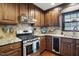 Updated kitchen with stainless steel appliances, granite countertops, and rich wood cabinetry at 203 Marlowe Dr, Dunn, NC 28334