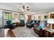 Cozy living room with hardwood floors, leather furniture, and ample natural light at 203 Marlowe Dr, Dunn, NC 28334