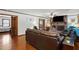 Warm living room showcasing hardwood floors, brick fireplace, and easy access to other rooms at 203 Marlowe Dr, Dunn, NC 28334