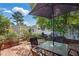 Brick patio with outdoor seating, an umbrella, and well-maintained landscaping at 203 Marlowe Dr, Dunn, NC 28334