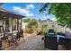 Landscaped brick patio with black furniture, umbrella, and fenced perimeter at 203 Marlowe Dr, Dunn, NC 28334