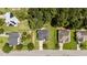 Aerial view of a home with a gray roof, lush green lawns, and mature trees at 204 Trevor Ridge Dr, Holly Springs, NC 27540