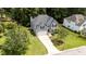 Aerial view of two-story house with gray siding, manicured lawn and mature trees at 204 Trevor Ridge Dr, Holly Springs, NC 27540