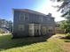View of the backyard featuring a well-maintained lawn and the home's gray vinyl siding at 204 Trevor Ridge Dr, Holly Springs, NC 27540