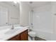 Well-lit bathroom features a vanity with sink, toilet and shower over bath at 204 Trevor Ridge Dr, Holly Springs, NC 27540