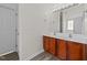 Bathroom featuring double sinks, a large mirror, and vanity with dark wood cabinets at 204 Trevor Ridge Dr, Holly Springs, NC 27540