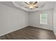 Bright bedroom features a tray ceiling, ceiling fan, and hardwood floors at 204 Trevor Ridge Dr, Holly Springs, NC 27540