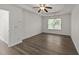 This is a spacious bedroom featuring vinyl floors, a window, and a ceiling fan at 204 Trevor Ridge Dr, Holly Springs, NC 27540