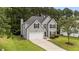 Beautiful two-story home with gray siding, black shutters, and a spacious driveway at 204 Trevor Ridge Dr, Holly Springs, NC 27540