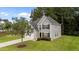 Well-maintained two-story home with gray siding, black shutters, and a lush green lawn at 204 Trevor Ridge Dr, Holly Springs, NC 27540