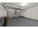 Spacious two car garage featuring an automatic door and room for storage and refuse bins at 204 Trevor Ridge Dr, Holly Springs, NC 27540