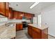 Kitchen features stainless steel appliances, granite counters, wood cabinets, and an island at 204 Trevor Ridge Dr, Holly Springs, NC 27540
