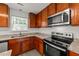 Kitchen with stainless steel appliances, granite counters, and wood cabinets at 204 Trevor Ridge Dr, Holly Springs, NC 27540