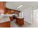 Kitchen features stainless steel appliances, granite counters, wood cabinets, and an island at 204 Trevor Ridge Dr, Holly Springs, NC 27540