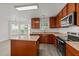 Eat-in kitchen features hardwood floors, granite counters, wood cabinets, and stainless appliances at 204 Trevor Ridge Dr, Holly Springs, NC 27540
