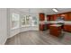 Eat-in kitchen features hardwood floors, modern lighting, granite counters, and wood cabinets at 204 Trevor Ridge Dr, Holly Springs, NC 27540