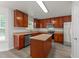 Bright kitchen features stainless steel appliances, granite counters, and wood cabinets at 204 Trevor Ridge Dr, Holly Springs, NC 27540