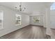 Bright living area with hardwood floors, natural light, and an elegant chandelier at 204 Trevor Ridge Dr, Holly Springs, NC 27540