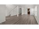 Open-concept living space with hardwood floors, staircase, and ample natural light at 204 Trevor Ridge Dr, Holly Springs, NC 27540