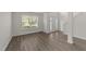 Bright living room with hardwood floors, large windows, and natural light at 204 Trevor Ridge Dr, Holly Springs, NC 27540