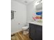 Bathroom features a dark vanity, white marble countertop, and modern gold fixtures at 205 S Pettigrew St, Raleigh, NC 27610
