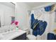 Stylish bathroom with a dark vanity, white marble countertop, and modern fixtures at 205 S Pettigrew St, Raleigh, NC 27610