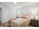 Bright bedroom with light-colored walls, hardwood floors, two end tables, and natural light at 205 S Pettigrew St, Raleigh, NC 27610