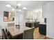 Dining room and kitchen space featuring modern lighting, cabinets and new floors, for an inviting atmosphere at 205 S Pettigrew St, Raleigh, NC 27610