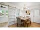 Dining room with new floors, seating, and modern chandelier lighting, excellent for hosting dinner parties at 205 S Pettigrew St, Raleigh, NC 27610