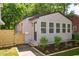 Side view showing exterior, landscaping, wooden fence, front entrance and address of the house at 205 S Pettigrew St, Raleigh, NC 27610