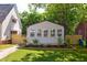 Charming exterior featuring a manicured lawn and neutral-colored siding with lovely curb appeal at 205 S Pettigrew St, Raleigh, NC 27610