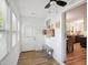 Hallway view featuring new flooring, modern white walls, and a bench for added convenience at 205 S Pettigrew St, Raleigh, NC 27610
