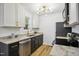 This modern kitchen features stainless appliances, stone countertops, and black lower cabinets at 205 S Pettigrew St, Raleigh, NC 27610