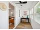 Office area with new flooring, a modern desk, and an inviting view to the living room at 205 S Pettigrew St, Raleigh, NC 27610