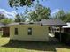 Backyard of the home featuring a covered parking area and mature landscaping at 2131 Dandridge Dr, Raleigh, NC 27610