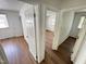 Hallway with white trim, wood-look flooring, and multiple entryways at 2131 Dandridge Dr, Raleigh, NC 27610