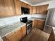 Kitchen with stainless steel appliances, light countertop, and wood cabinetry at 2131 Dandridge Dr, Raleigh, NC 27610