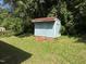 Outdoor shed in backyard featuring blue siding and a red roof at 2131 Dandridge Dr, Raleigh, NC 27610