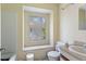 Bathroom with a tub, toilet, sink, and a window, showing some signs of use and needing repair at 2308 Stonesthrow Ct, Raleigh, NC 27610