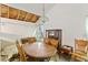 Dining room with a large wooden table, chairs, and exposed ceiling and wall needing repair at 2308 Stonesthrow Ct, Raleigh, NC 27610
