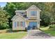 Charming two-story home with light yellow siding, blue shutters, and a single-car garage at 2308 Stonesthrow Ct, Raleigh, NC 27610