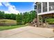 Backyard patio with pond, greenery, outdoor stone fireplace and patio seating underneath a covered porch at 233 Hein Dr, Clayton, NC 27527