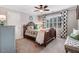 Comfortable bedroom featuring a ceiling fan, large window, and beautiful, patterned bedding at 233 Hein Dr, Clayton, NC 27527