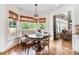 Charming breakfast nook features a built-in bench, round table, and large windows overlooking the lush backyard at 233 Hein Dr, Clayton, NC 27527