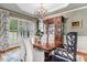 Elegant dining room with a chandelier, hardwood floors, and large windows with shutter blinds at 233 Hein Dr, Clayton, NC 27527