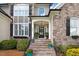 Inviting front entrance with stone steps, manicured landscaping, and a charming front door at 233 Hein Dr, Clayton, NC 27527