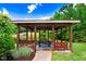 Open gazebo featuring benches and a picnic table with a scenic view of the pond at 233 Hein Dr, Clayton, NC 27527