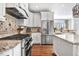 Modern kitchen featuring stainless steel appliances, granite countertops, and white cabinetry at 233 Hein Dr, Clayton, NC 27527