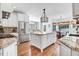 Bright kitchen boasts granite countertops, stainless steel appliances, and a large center island with a modern light fixture at 233 Hein Dr, Clayton, NC 27527