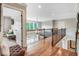 Upstairs landing with hardwood floors and wrought iron railing overlooking the foyer below at 233 Hein Dr, Clayton, NC 27527